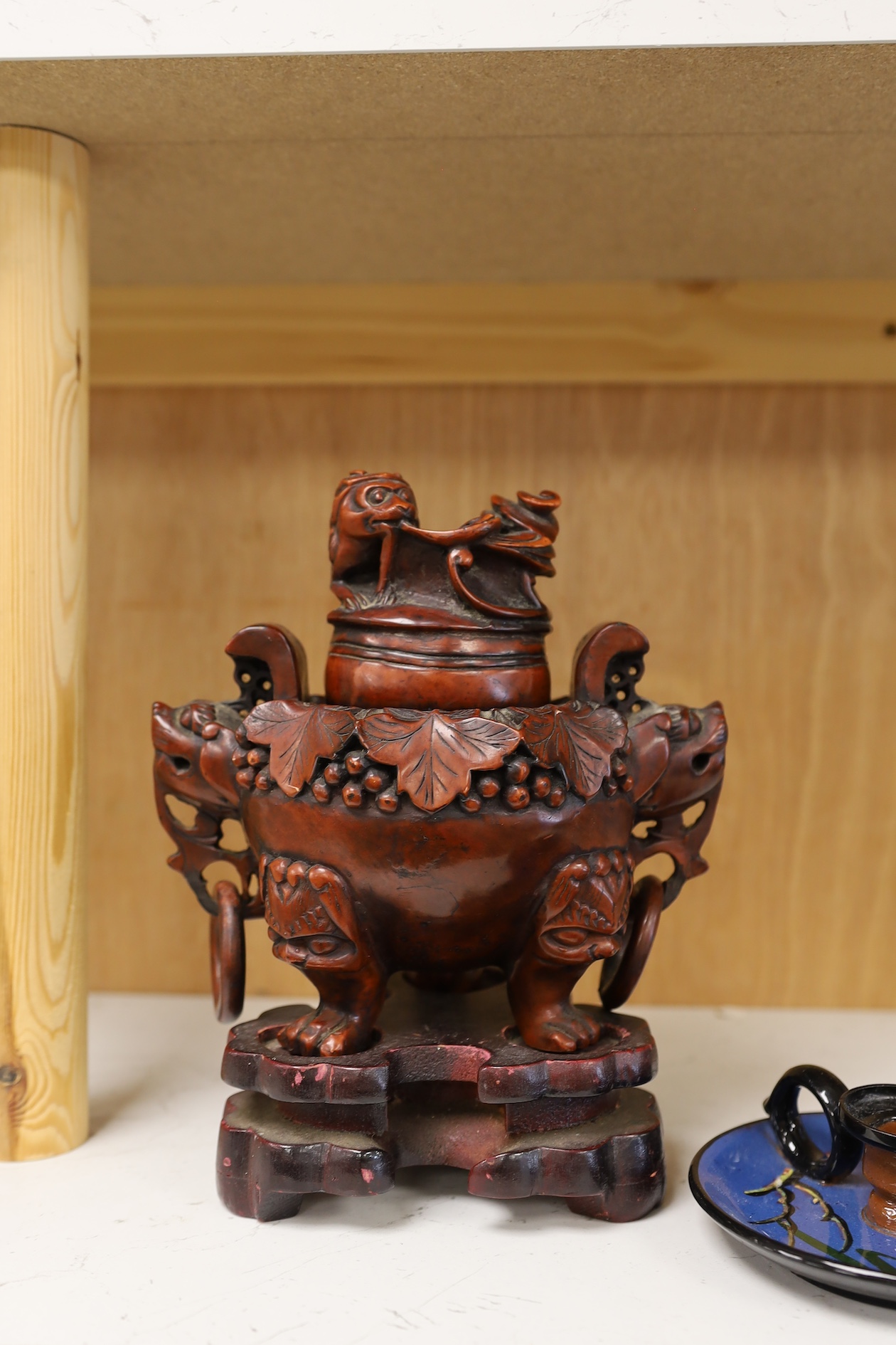 A Chinese composition tripod censer and cover, wood stand, 22.5cm high. Condition - fair